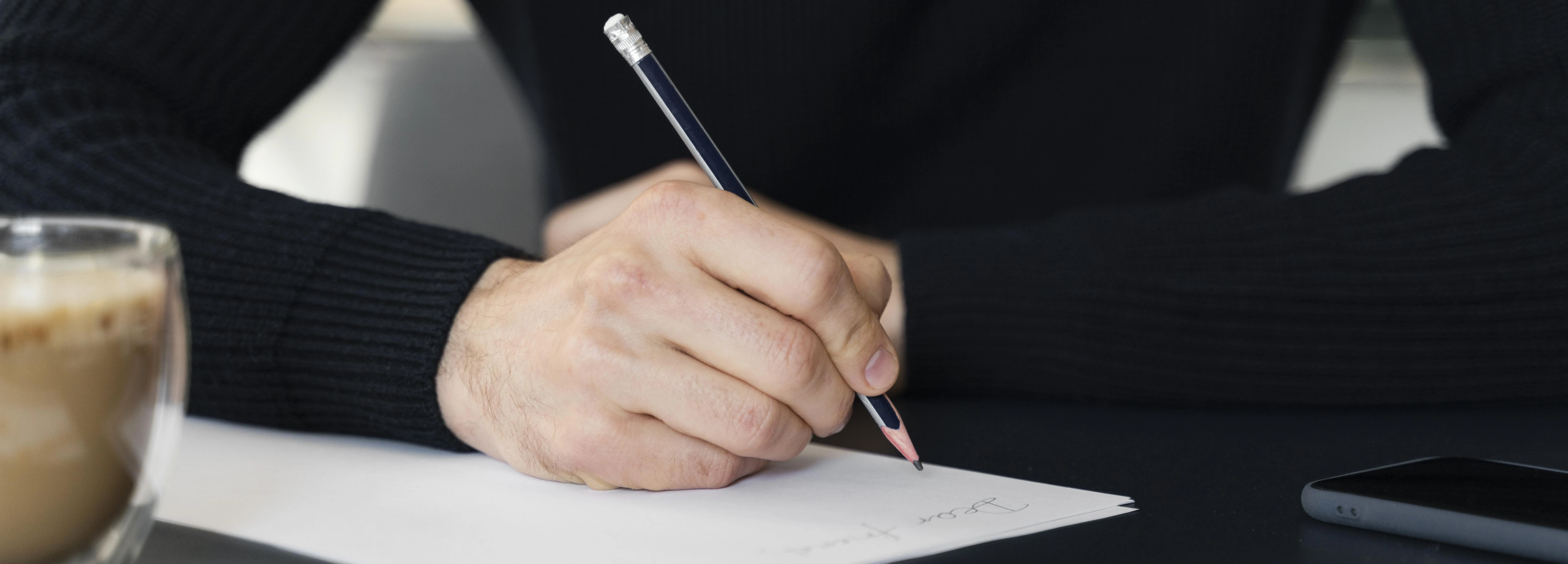 close-up-man-writing-letter1.webp